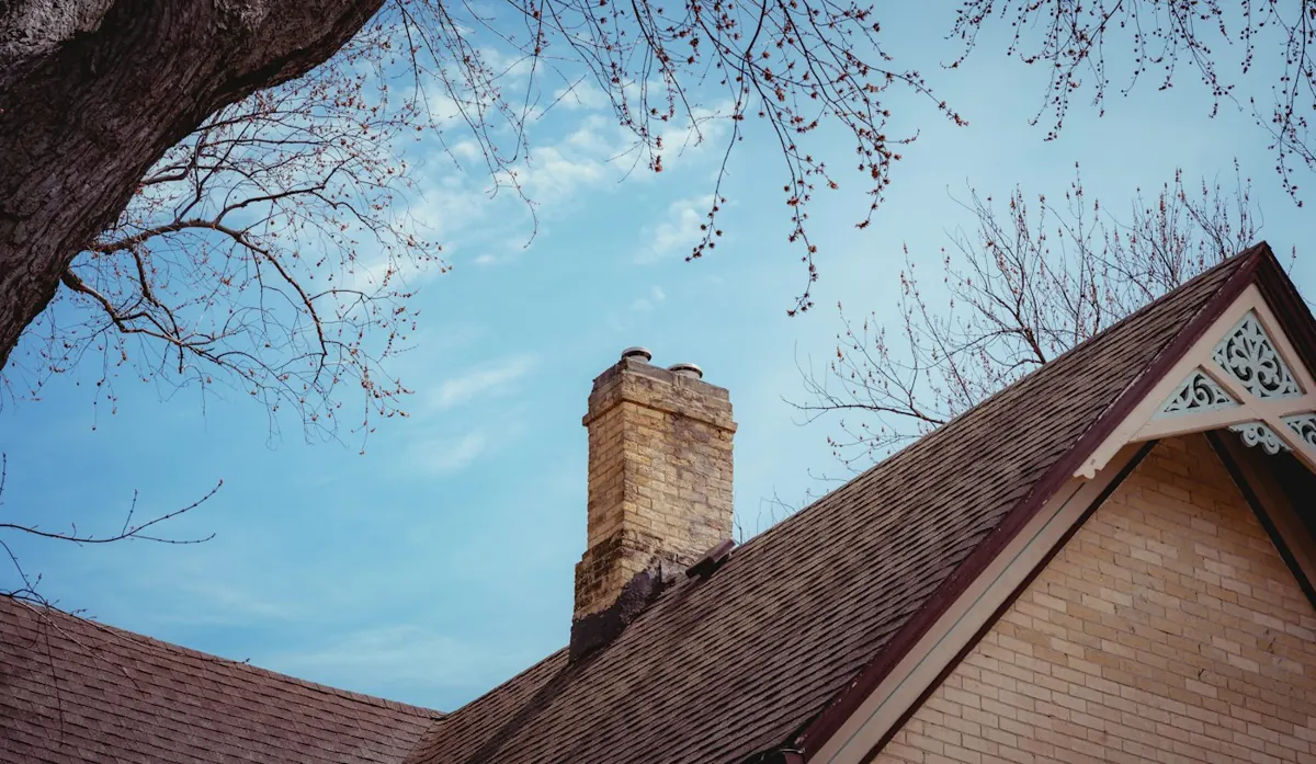 Brick chimney on a snowy roof in winter